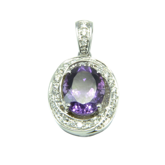 Beautiful pendant made with an oval purple amethyst and accented with white diamonds set in 14K white gold.